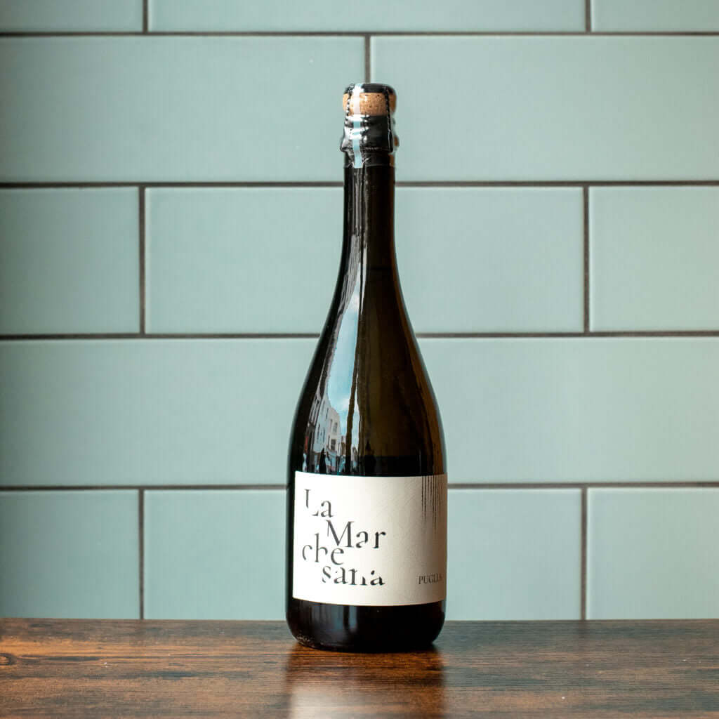 Carbonara recipe wine pairing with a bottle of La Marche Salata wine on a wooden table.